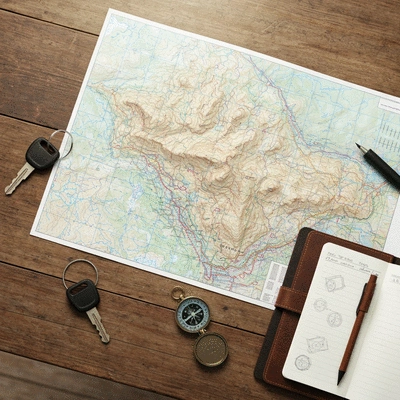 Off-road adventure planning with map and 4x4 keys on a table