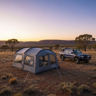 Modern off-road camping tent set up in a beautiful Australian landscape at sunrise
